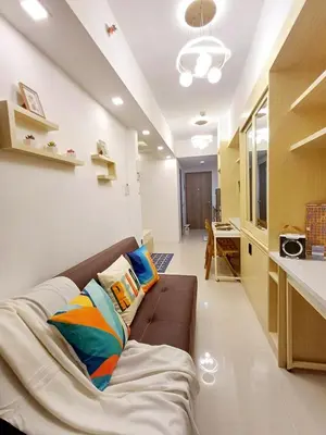 a living room with a couch with pillows on it at S Residences 942b near airport pasay in Manila