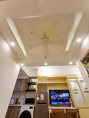 a room with a kitchen with a washer and a ceiling at S Residences 942b near airport pasay in Manila