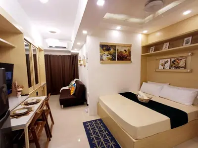 a bedroom with a bed and a desk in a room at S Residences 942b near airport pasay in Manila