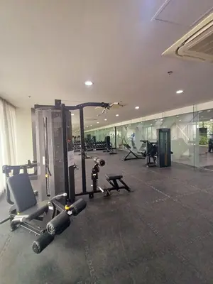 a gym with several treadmills and machines in a building at S Residences 942b near airport pasay in Manila