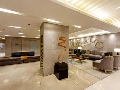 a lobby with a living room with couches and a sculpture at My Staycation moa area S Residences tower1 in Manila