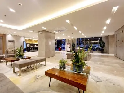 a lobby with couches and tables in a building at My Staycation moa area S Residences tower1 in Manila