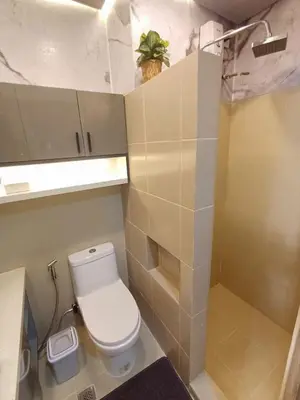 a small bathroom with a toilet and a sink at My Staycation moa area S Residences tower1 in Manila