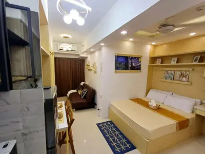 a small room with a bed and a couch at My Staycation moa area S Residences tower1 in Manila
