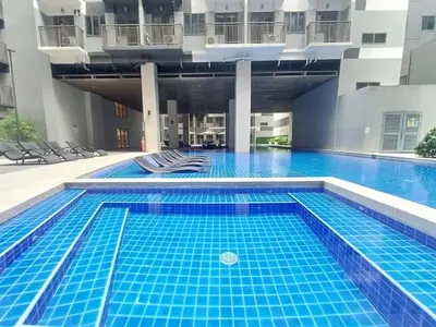 a large swimming pool with blue tiles in a building at My Staycation moa area S Residences tower1 in Manila
