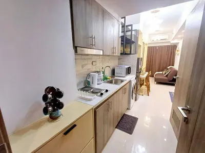 a small kitchen with a sink and a microwave at My Staycation moa area S Residences tower1 in Manila