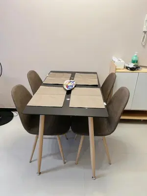 a dining room table with four chairs around it at Bonifacio global city, taguig in Manila