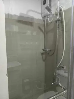 a shower with a glass door in a bathroom at Shore residence Tower D moa ecom view cozy bedroom in Manila