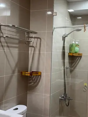 a bathroom with a shower with a glass door at BGC One Uptown 2bedroom with balcony and 1 free parking in Manila