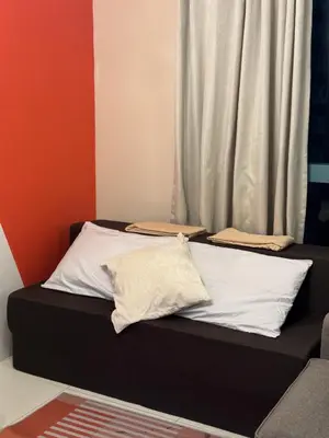 a bed with two pillows on it in a room at BGC One Uptown 2bedroom with balcony and 1 free parking in Manila