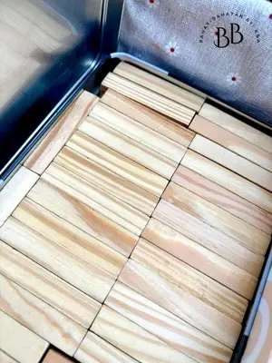 a close up of a wooden cutting board on a machine at Bahay-Bahayan by K&A at Azure Urban Resort Residences in Manila