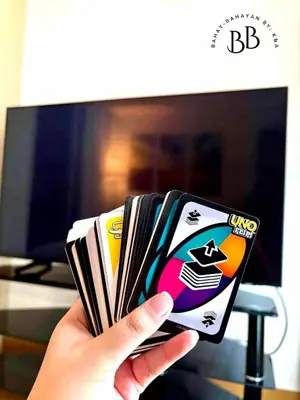 a person holding up a deck of playing cards at Bahay-Bahayan by K&A at Azure Urban Resort Residences in Manila