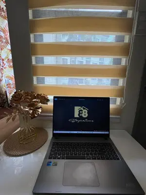 a laptop computer sitting on a desk next to a window at D88Staycations 105- Condo Staycation beside Enchanted Kingdom in Santa Rosa