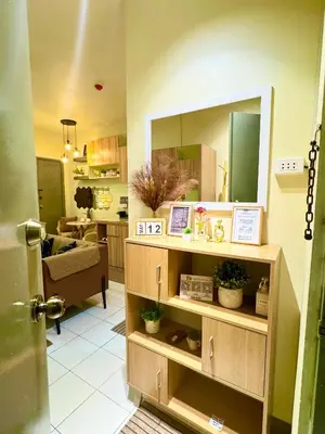 a room with a mirror and a living room at D88Staycations 105- Condo Staycation beside Enchanted Kingdom in Santa Rosa