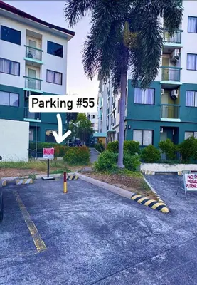 a street sign in a parking lot in front of a building at D88Staycations 105- Condo Staycation beside Enchanted Kingdom in Santa Rosa