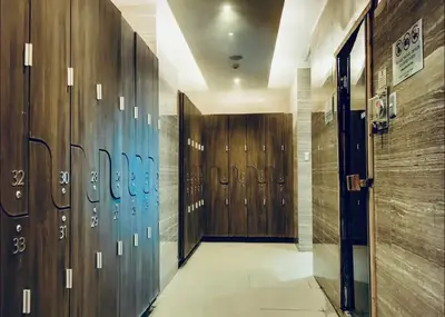 a hallway with a row of lockers in a gym at Gramercy Residences Spacious 1 BR Loft FREE Amenities in Manila