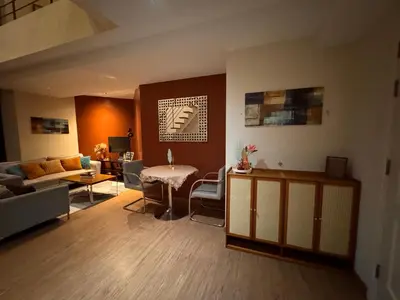 a living room with a couch and a table at Gramercy Residences Spacious 1 BR Loft FREE Amenities in Manila