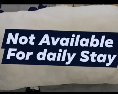 a white pillow with a not available for dailystay sign on it at Staycation at Solemare Parksuites Tower B Near DFA, Mall of Asia, Ayala Mall, Parqual Mall , COD, Conrad, Solaire, Okada Manila, & NAIA,1 Bedroom in Manila