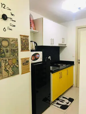 a kitchen with a black and yellow counter top at amaya in Manila