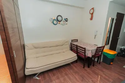 a living room with a couch and a table at The Quirk Inn Air residence Makati Swim Gym Park Eat Laugh 3301 in Manila