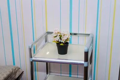 a small table with a potted plant on it at Urban Hideaway Cozy Makati Giggles Swim Gym Park Laugh Eat 3352 in Manila
