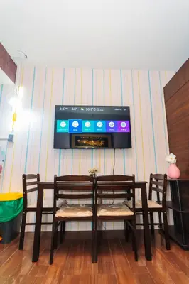 a room with a table and two chairs and a tv at Urban Hideaway Cozy Makati Giggles Swim Gym Park Laugh Eat 3352 in Manila