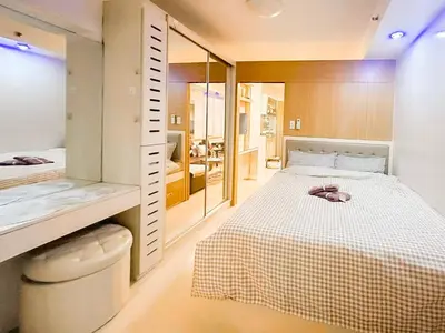 a bedroom with a large bed and a bathroom at 907 Air Condo Urban Retreat 1BR w City View MOA in Manila