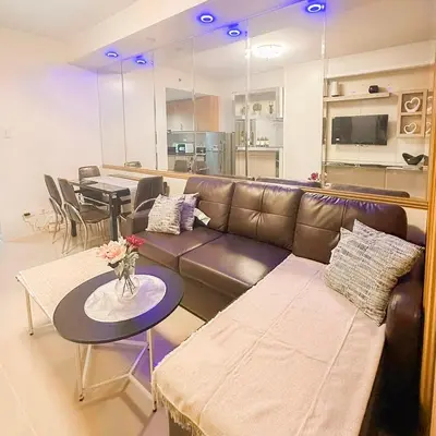 a living room with a couch and a table at 907 Air Condo Urban Retreat 1BR w City View MOA in Manila