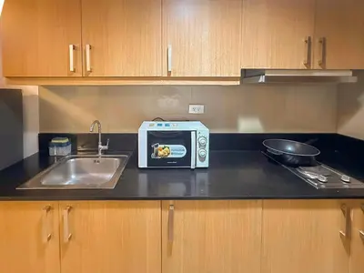 a kitchen counter with a toaster and a sink at 907 Air Condo Urban Retreat 1BR w City View MOA in Manila
