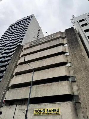 a tall building with a hong bathin sign on it at Business Studio in Salcedo Village Makati in Manila