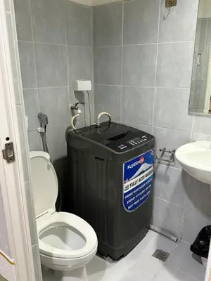 a bathroom with a toilet and a trash can at Sea Residences at Rose stayction in Manila