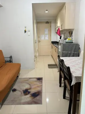 a kitchen with a dining table and a kitchen with a counter at Sea Residences at Rose stayction in Manila