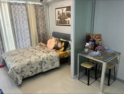 a bedroom with a bed and a table and a mirror at Azure's Best by Condo Suites PH in Manila
