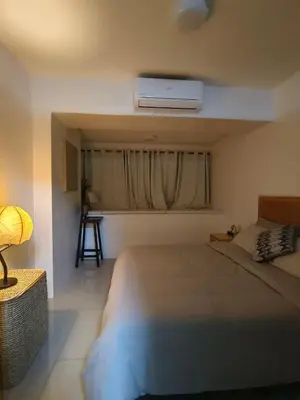 a bedroom with a bed and a window with a heater at Barkada Room by Metro Staycation in Manila