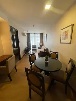 a living room with a table and chairs and a couch at A venue Residences Tower 10i in Manila
