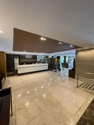a large room with a lobby with a counter at A venue Residences Tower 10i in Manila