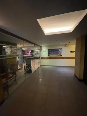 a large empty room with a television and a table at A venue Residences Tower 10i in Manila