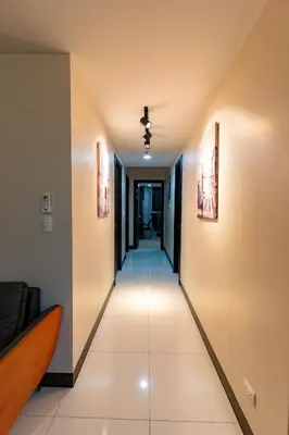 a hallway in a house with a long corridor at 3BR Modern Uptown Parksuites BGC with bathtub in Manila