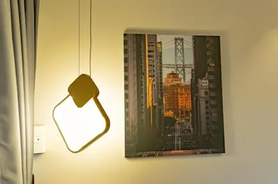 a picture hanging on a wall next to a lamp at 3BR Modern Uptown Parksuites BGC with bathtub in Manila