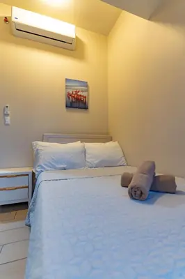 a bedroom with a large bed with white sheets at 3BR Modern Uptown Parksuites BGC with bathtub in Manila