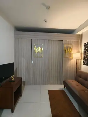 a living room with a couch and a table at Couple or Barkada Room in Manila