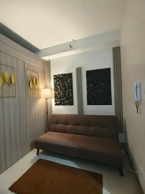 a living room with a couch in a room at Couple or Barkada Room in Manila
