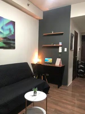 a bedroom with a bed and a desk with a computer at Modern Style and Family Friendly in Manila