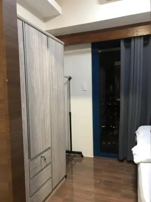 a room with a closet with a sliding door at Modern Style and Family Friendly in Manila