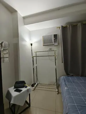 a room with a room with a bed and a fan at Shore by Metro Staycation in Manila