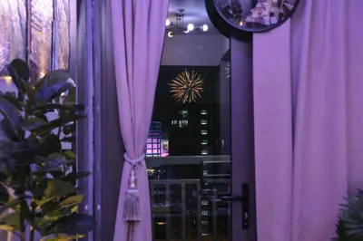 a purple room with a window with purple curtains at Sonens Hem S Residences in Manila