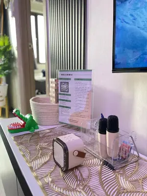 a table with a toaster and two skeins of yarn at Sonens Hem S Residences in Manila