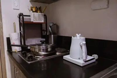 a kitchen with a counter top with a appliance on it at Sonens Hem S Residences in Manila