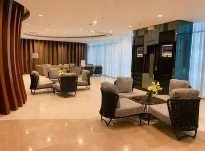 a lobby with chairs and a table and a waiting room at Shore 2 Residences MOA NAIA in Manila