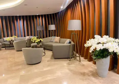 a lobby with couches and flowers in a room at Shore 2 Residences MOA NAIA in Manila